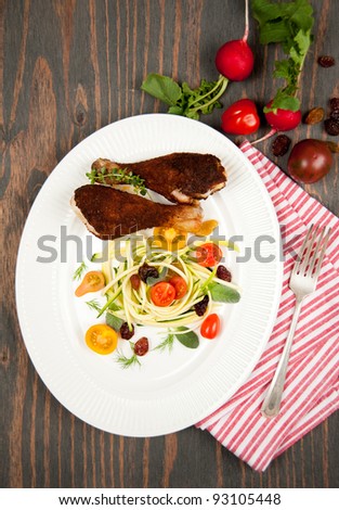 Grilled Chicken Drumsticks Served with Zucchini Salad and Tomatoes