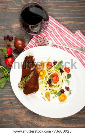 Grilled Chicken Drumsticks Served with Zucchini Salad and Red Wine