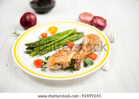 Grilled Chicken Drumsticks Served with Young Asparagus and Tomatoes