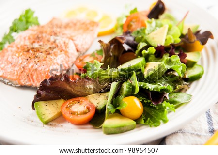 Salmon Baked and Served with Tomatoes, Cucumbers, Avocado, Greens