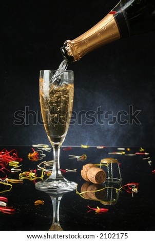 Pouring a champagne flute for celebration time (with confetti)