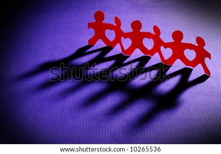 stock photo : Paper people holding hands together making heart shapes