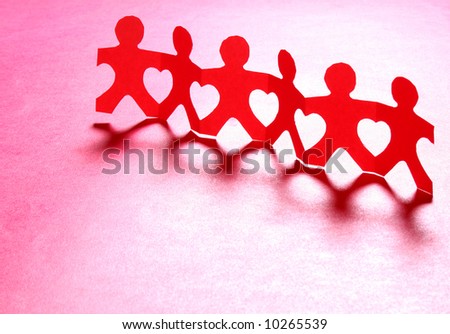 Paper people holding hands together making heart shapes