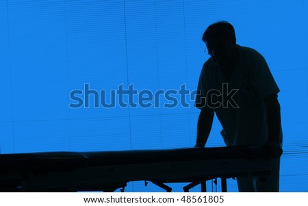 Doctor silhouette with an hospital bed at a hospital