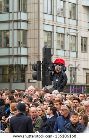 LONDON - APR 18 : crowd and journalists pictured near St Paul at the funeral of Margaret Thatcher on April 18th, 2013, in London, UK. The procession arrived at Saint Paul and started in Westminster.