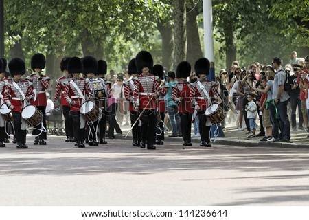 LONDON - JUN 30: The colorful changing of the guard ceremony at Buckingham Palace on June 30th, 2013 in London, UK. It is one of England\'s most popular visitor attractions.
