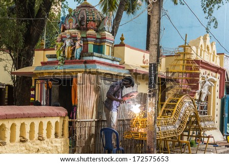 Bangalore, India - Jan 12 : Man working on the maintenance of a Hindu temple pictured on January 12, 2014 in Bangalore City, India. Hinduism is the dominant religion in India.