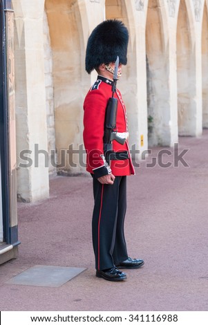WINDSOR, ENGLAND - JULY 24: Royal Guard holding gun on duty pictured on July 24th, 2015, in Windsor Castle, Windsor, UK. Windsor castle is one of the official residences of the British Royal Family.
