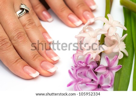 Professional manicure nails on white background with flowers