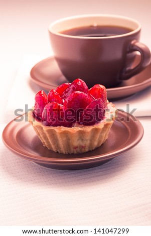 Strawberry dessert in Waffle Basket with Cup of Hot Tea