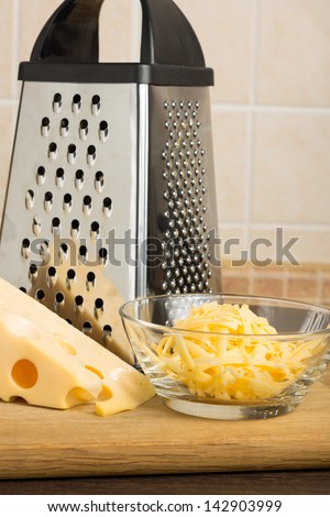 Grated Yellow Cheese with Grater at the kitchen