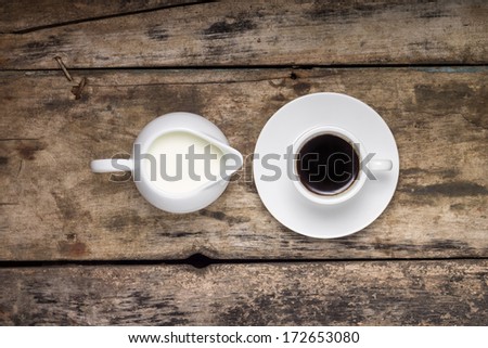 Coffee. Cup of Coffee with Milk Jug on Wood Background. Top View