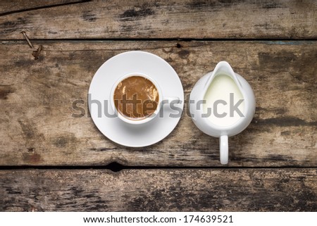 Coffee. Cup of Coffee with Milk Jug on Wood Background.  Top View