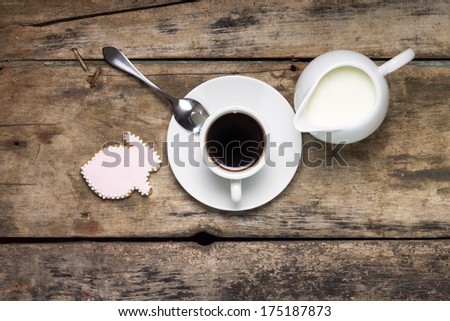 Coffee with gingerbread rabbit on wood background. Easter Background. Top View