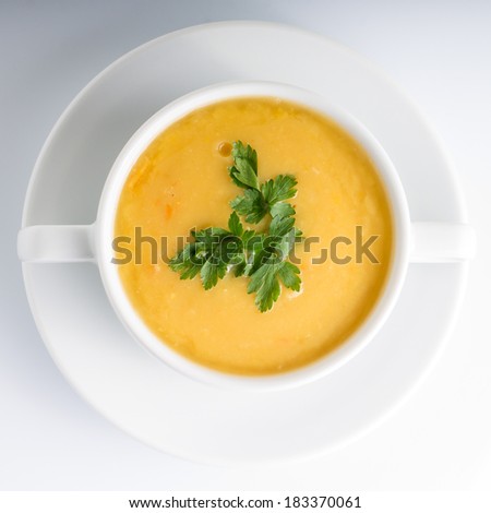 Pea soup in White Bowl on white background. Top View