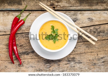 Creative cuisine. Pea Soup with chopstick on wood background