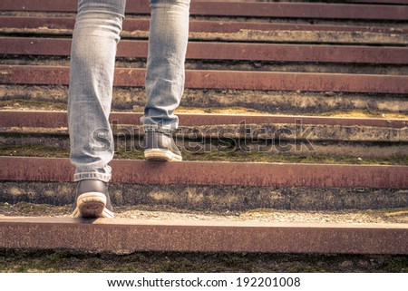 Girl walking on stairs. Female legs on the road