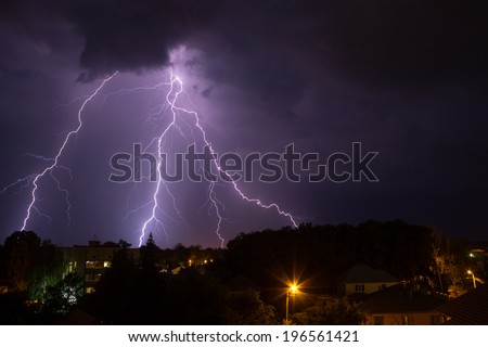Lightning in night sky over small town