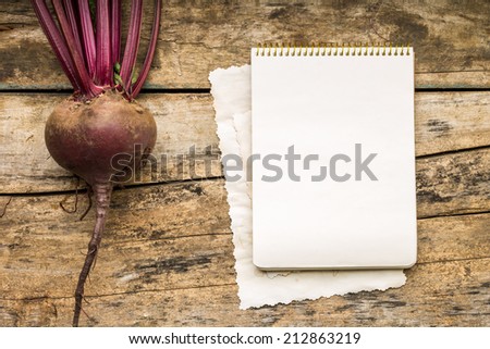 Menu background. Vegetables on table with cook book. Cooking with recipe book. Red beet