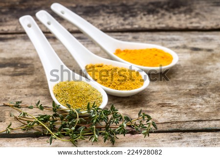 Spices recipe background. Diversity of spice powder mix with branch of thyme