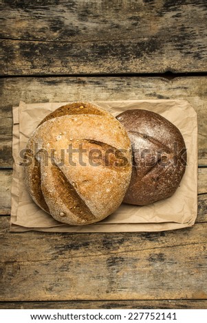 Two loaf of bread on paper bag. Bakery background