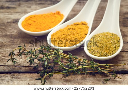 Various spice mix with branch of thyme on wooden table. Vintage spices background