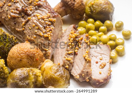 Sliced roast beef with grilled vegetables on white plate. Close up eco food menu background