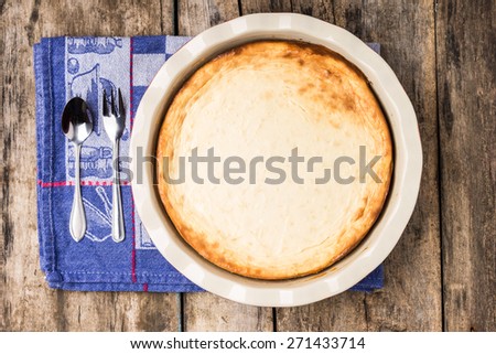 Fresh baked cheesecake on wooden table. Dessert cooking recipe background. Top view image