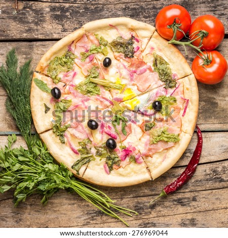 Delicious pizza with ingredients around. Recipe and menu pizza on wood background