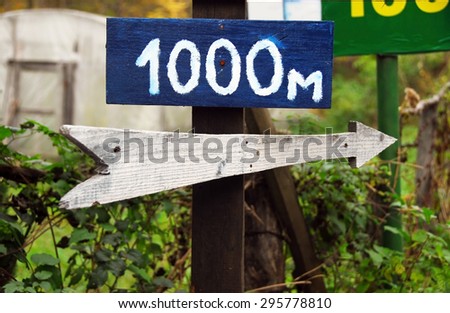 Rustic wooden road right direction arrow sign
