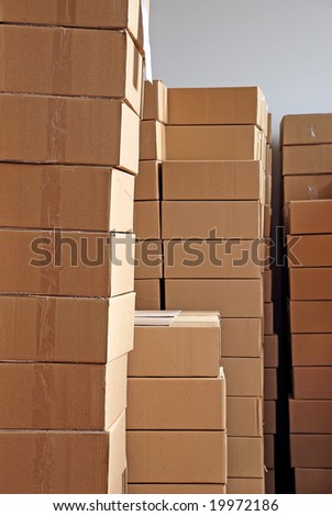 piles of paper boxes with goods in storage