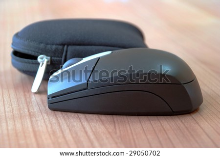 computer black wireless mouse with bag on desk
