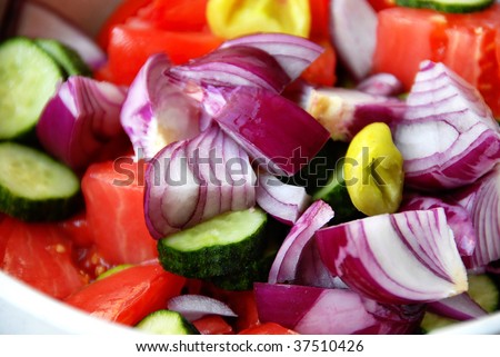 various cut fresh vegetables for salad closeup