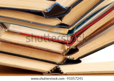 old dusty opened books stack on table