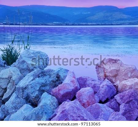 blue and purple stones on riverbank over cyan Danube river landscape