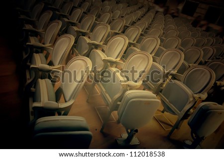 background of empty theater chairs