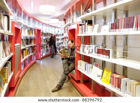 man in book store reading