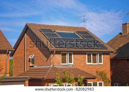 House with solar panels on roof - regenerative energy system electricity generation