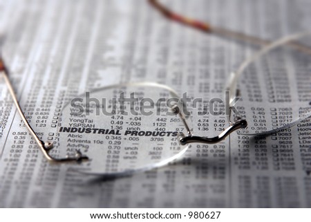 Spectacles on a newspaper with highlight on words \'Industrial Products\'