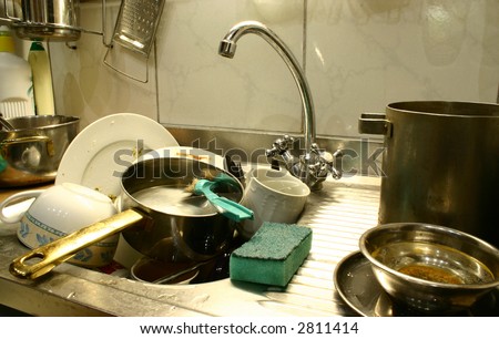 Dirty dishes in the kitchen\'s sink ready to start washing