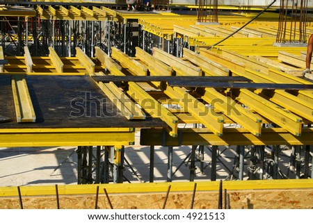 View at yellow constructions which are used to build flat board for a new level