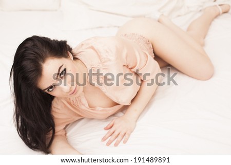 Sexy brunette lingerie woman on the bed