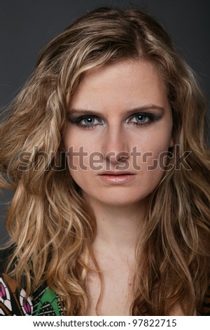 Blonde beautiful woman portrait on gray isolated background