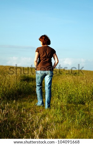 Woman goes on meadow