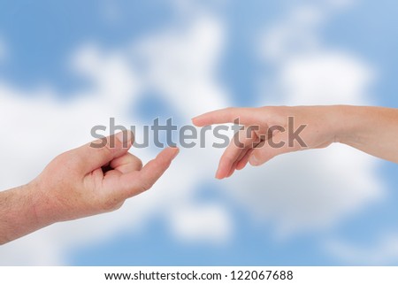 Two hands reach each other in