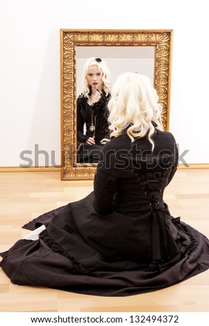 Woman sitting on the floor in front of the mirror