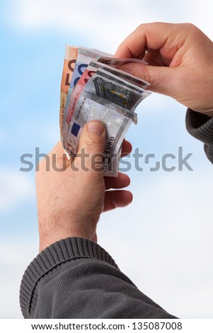 Hands holding banknotes