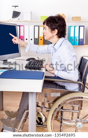 Sitting in a wheelchair working at desk