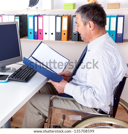 Man in wheelchair at desk