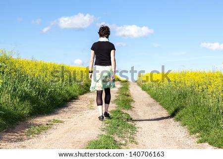 Woman walks alone in nature walk